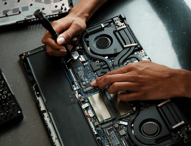 Επισκευή laptop σε τεχνικό εργαστήριο με ανοιχτό καπάκι και εργαλεία